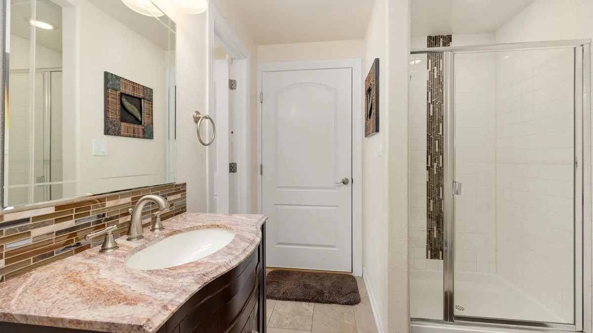 Shower walls being tiled during a remodel in Anaheim, CA